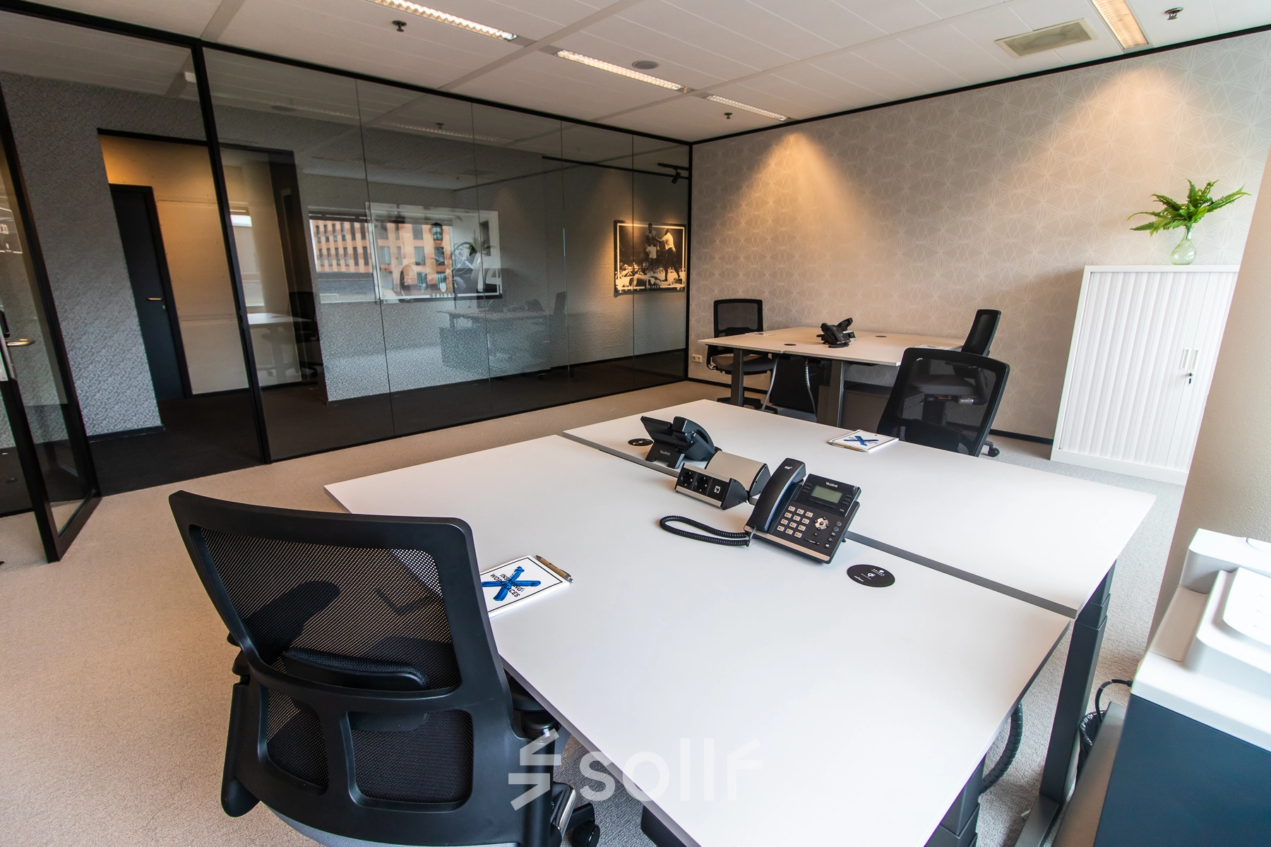 Modern office space in Amsterdam Zuidas with sleek, furnished workstations and a view of Gustav Mahlerplein. Ideal for those seeking office space rental with flexible options.