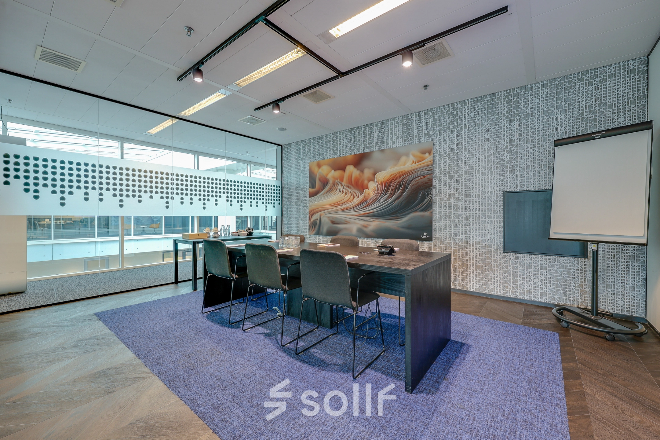 Spacious conference room in Amsterdam Zuidas with a large table, chairs, and modern decor, ideal for office space rental.