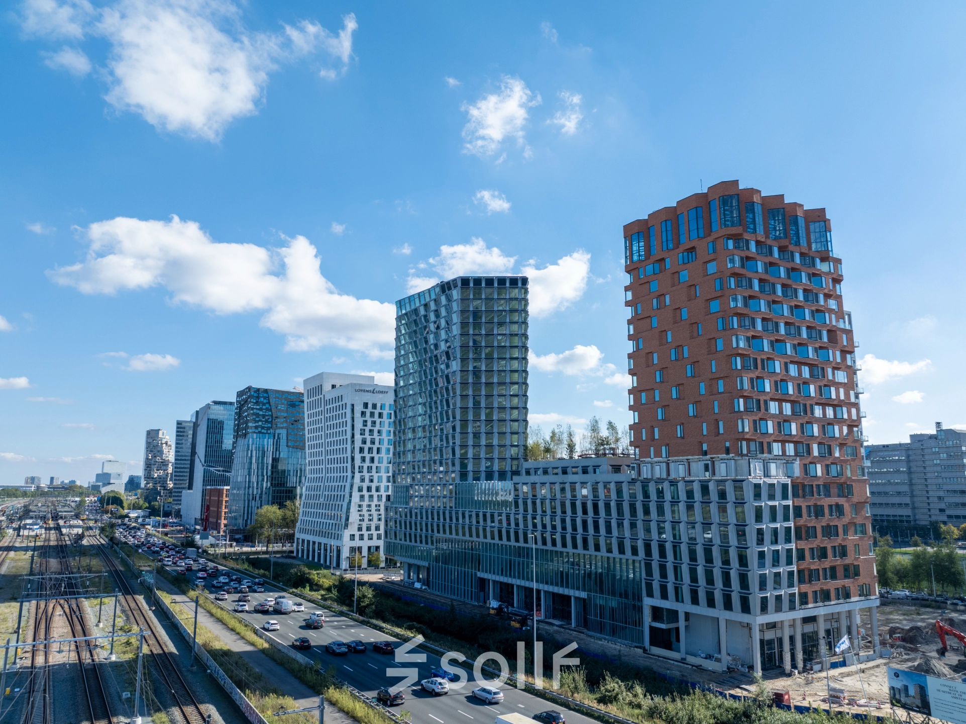 Exterior view of modern office buildings in Amsterdam Zuidas, showcasing potential office space rental at Hildegard Von Bingenstraat 44.