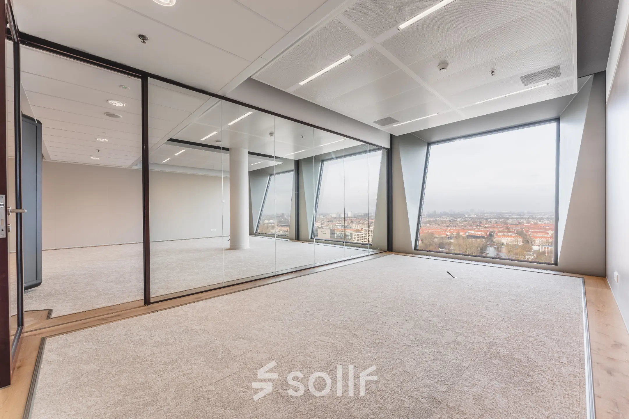 Bright office space at Hildegard Von Bingenstraat 44 in Amsterdam Zuidas, featuring large windows and glass partitions, available for office space rental.