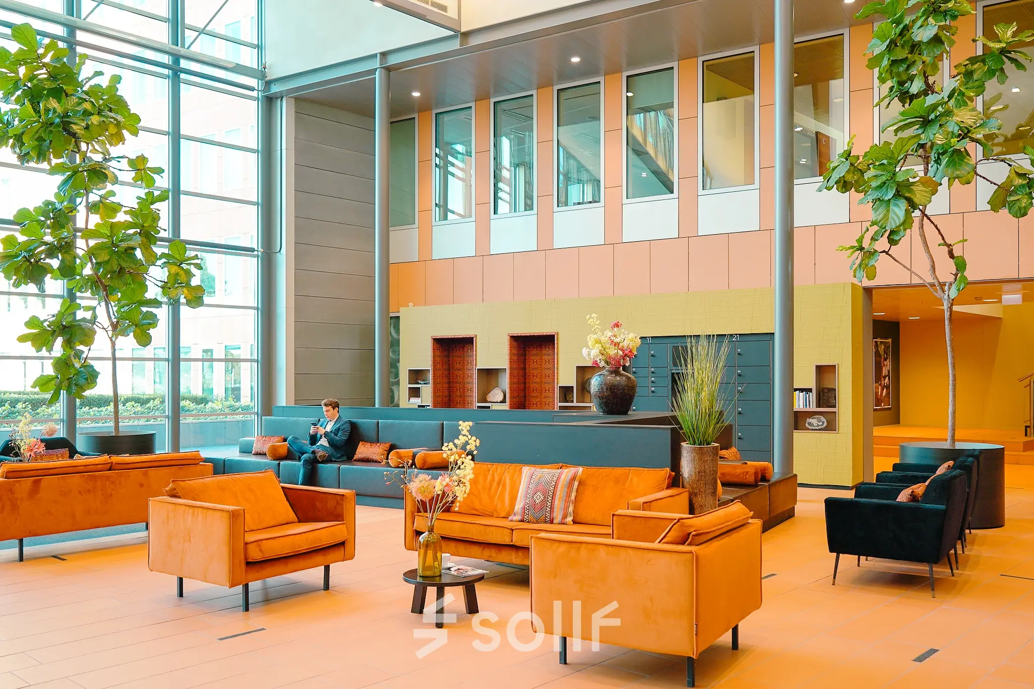 Spacious and bright office lounge at Jachthavenweg 109, Amsterdam Zuidas, offering comfortable seating with modern furnishings, ideal for informal meetings. Consider this vibrant office space rental for your next business move.