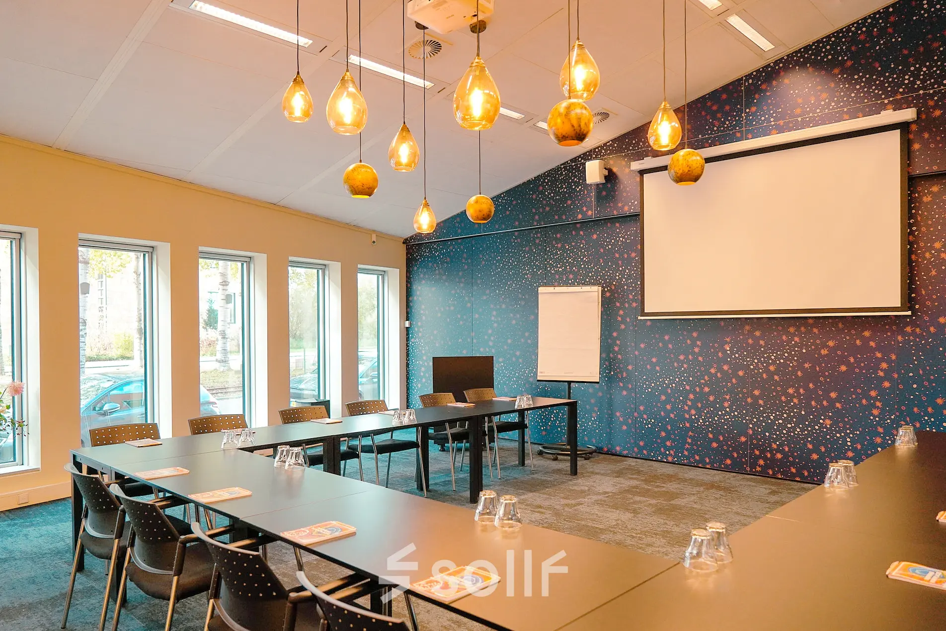 Spacious conference room at Jachthavenweg 109, Amsterdam Zuidas with modern lighting, large screen, and seating arrangement, ideal for office space rental.