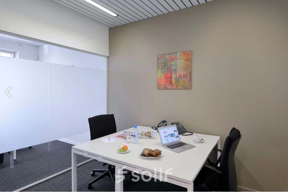 Modern furnished office for rent at Lange Lozanastraat 142, Antwerp Center, featuring a bright workspace with chairs and a desk, ideal for professionals looking for office space rental.