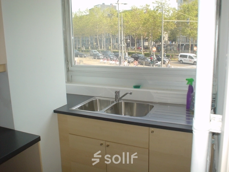 Office space rental with a kitchenette at Amerikalei 78A, Antwerpen Zuid, featuring a double sink beneath a window with city views.