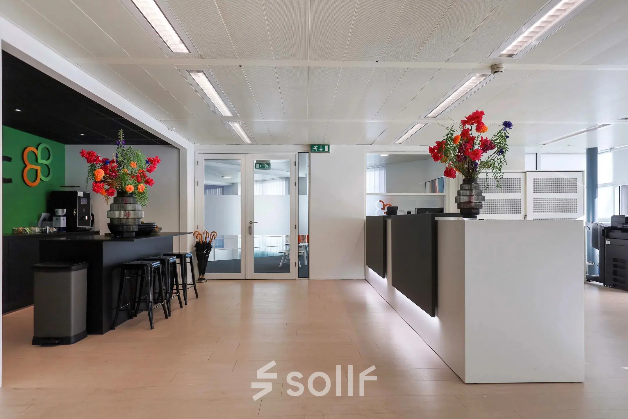 Modern office interior at Prins Willem-Alexanderlaan 301, Apeldoorn with contemporary furnishings and floral decorations, available for office space rental.