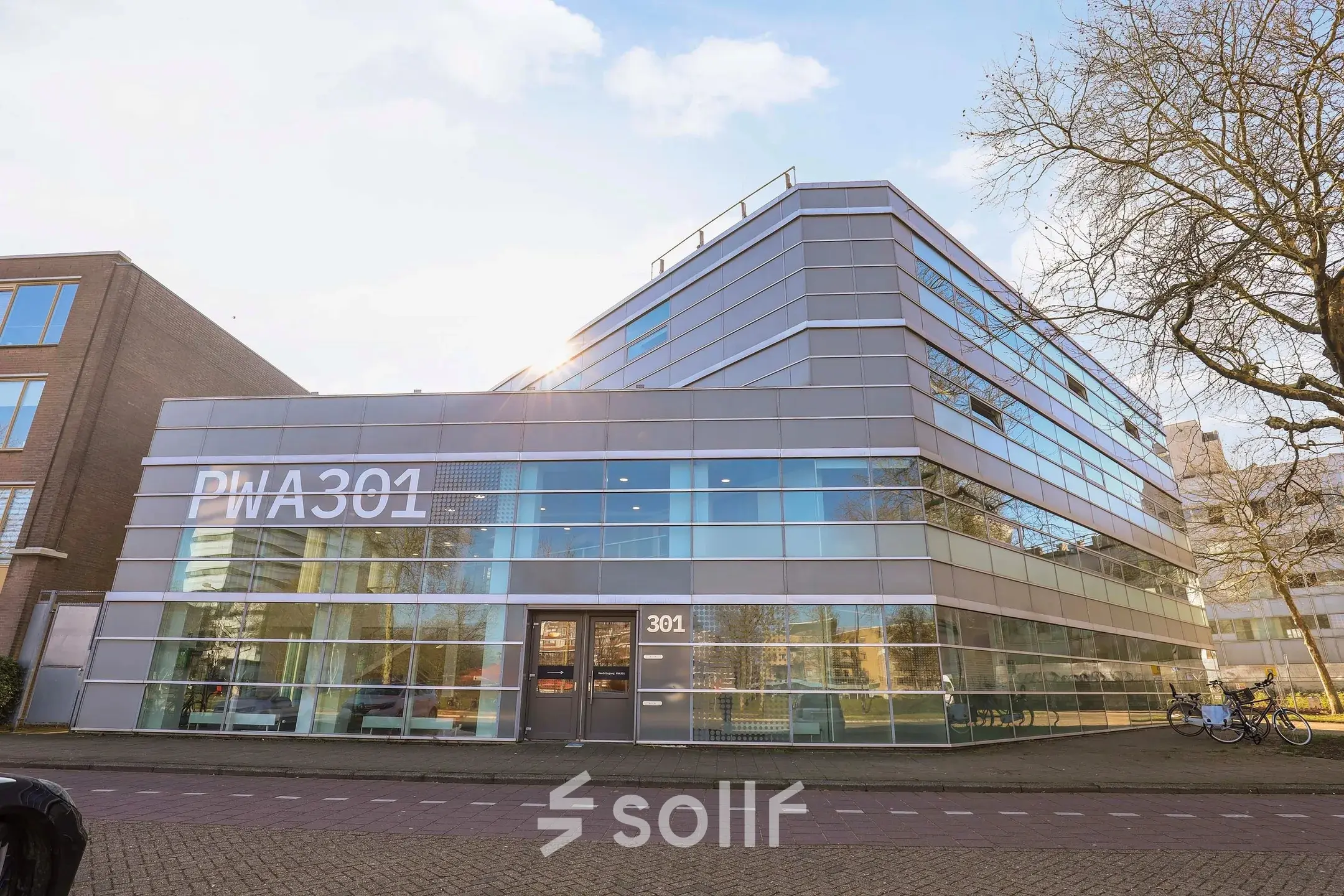 Exterior view of office building at Prins Willem-Alexanderlaan 301, Apeldoorn, showcasing a modern design with large windows. Ideal for office space rental.