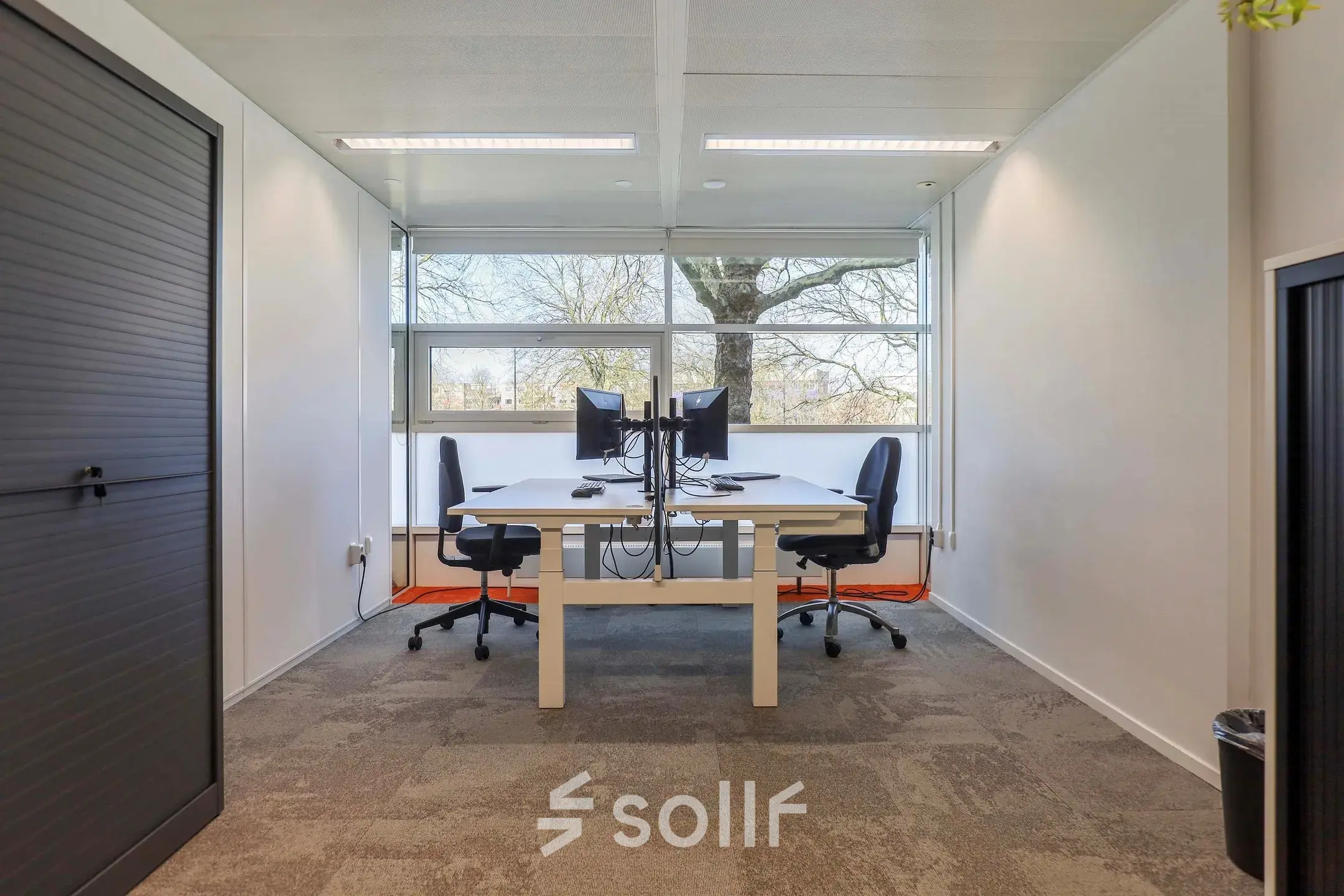 Furnished office space at Prins Willem-Alexanderlaan 301, Apeldoorn, featuring desks with computer monitors and chairs. Perfect for rent office space seekers.