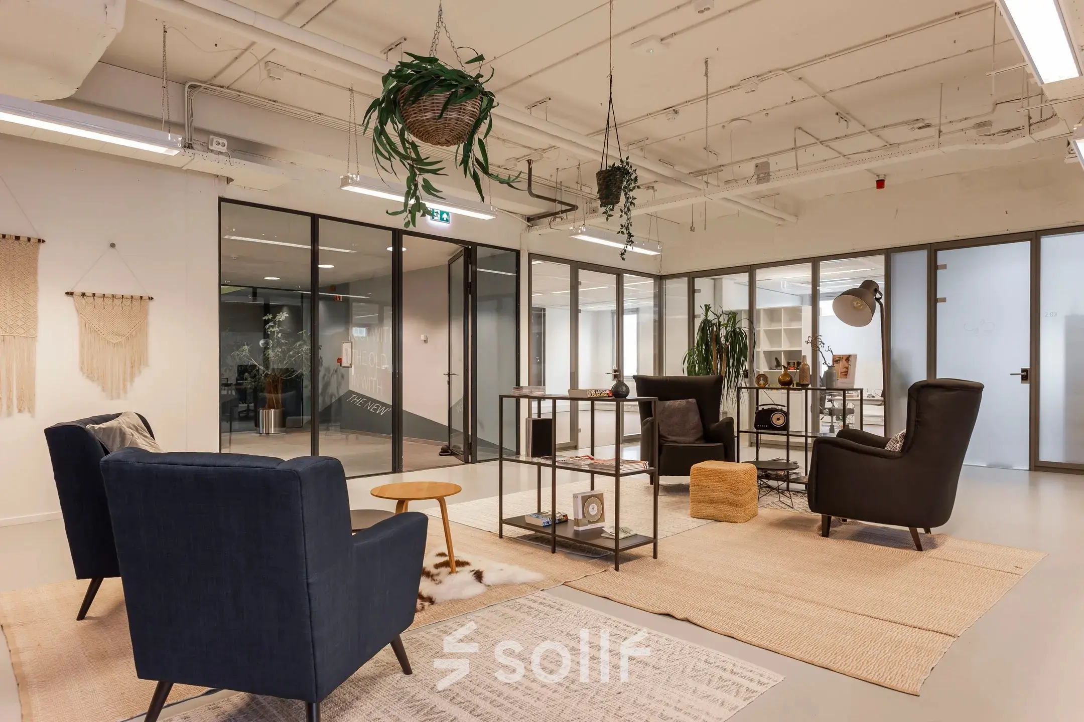 Comfortable office space at Roggestraat 111, Apeldoorn, featuring modern seating and decorative plants, available for rent.