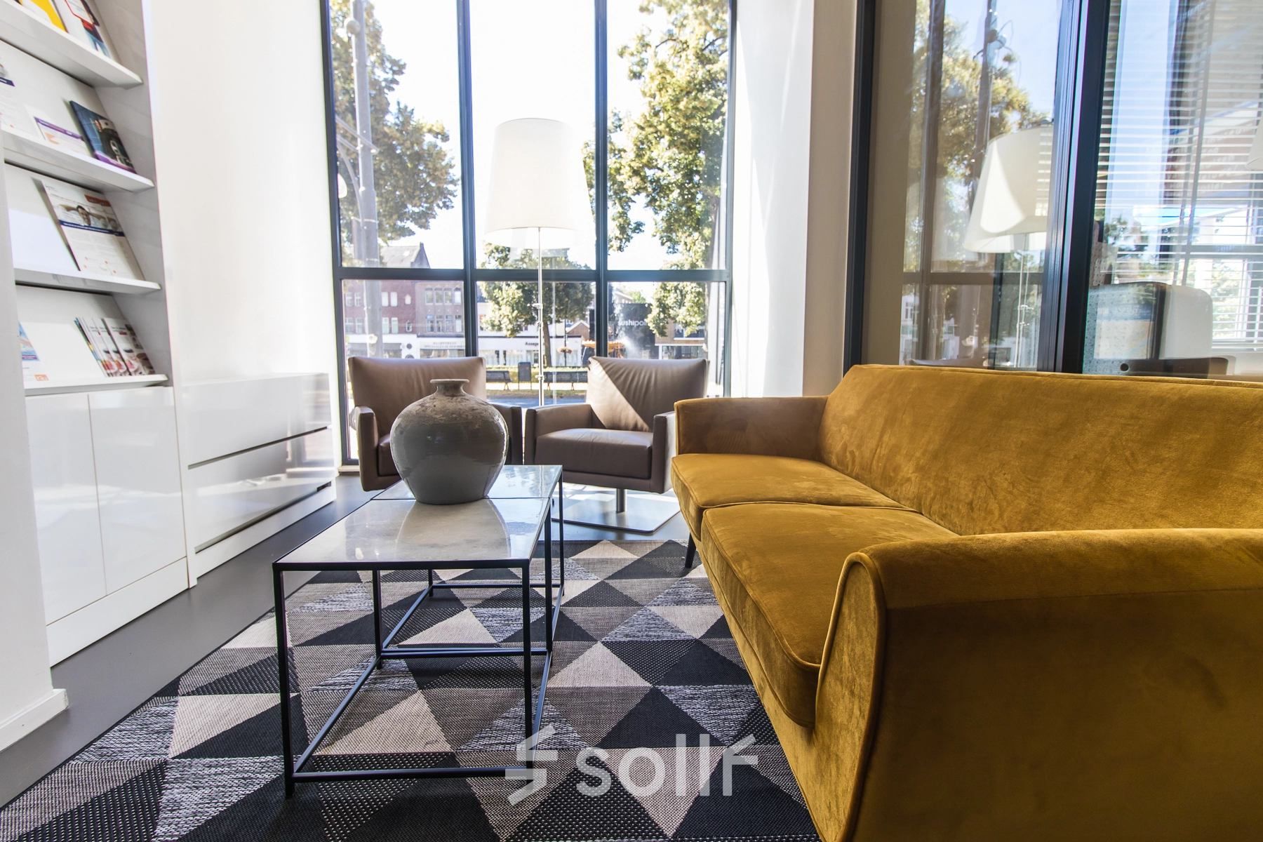 Furnished office space at Jansbuitensingel 7 in Arnhem Centrum with modern seating and large windows, ideal for rent office space seekers.