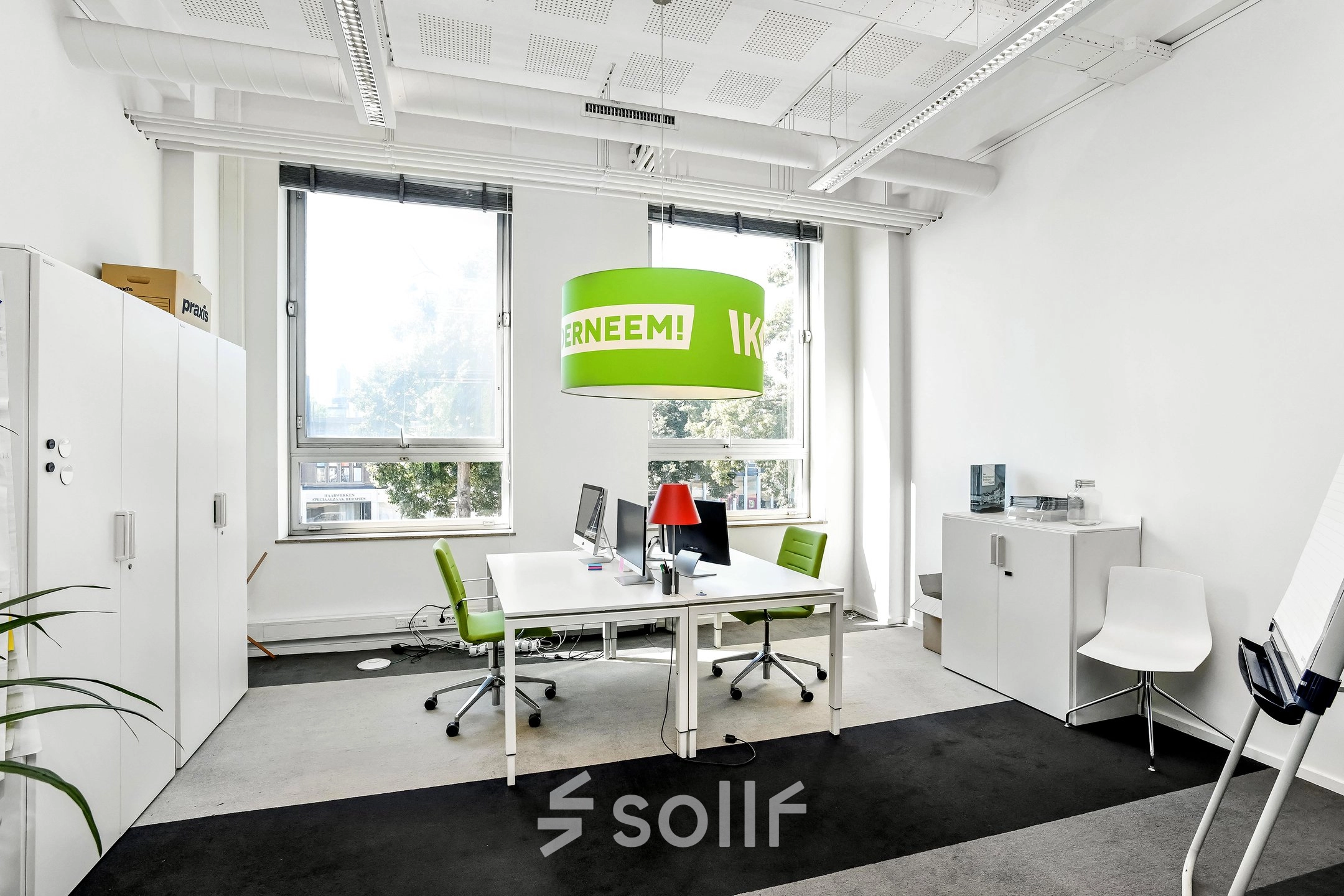 Bright furnished workspace at Jansbuitensingel 7, Arnhem Centrum, ideal for office space rental with modern desks, chairs, and large windows.