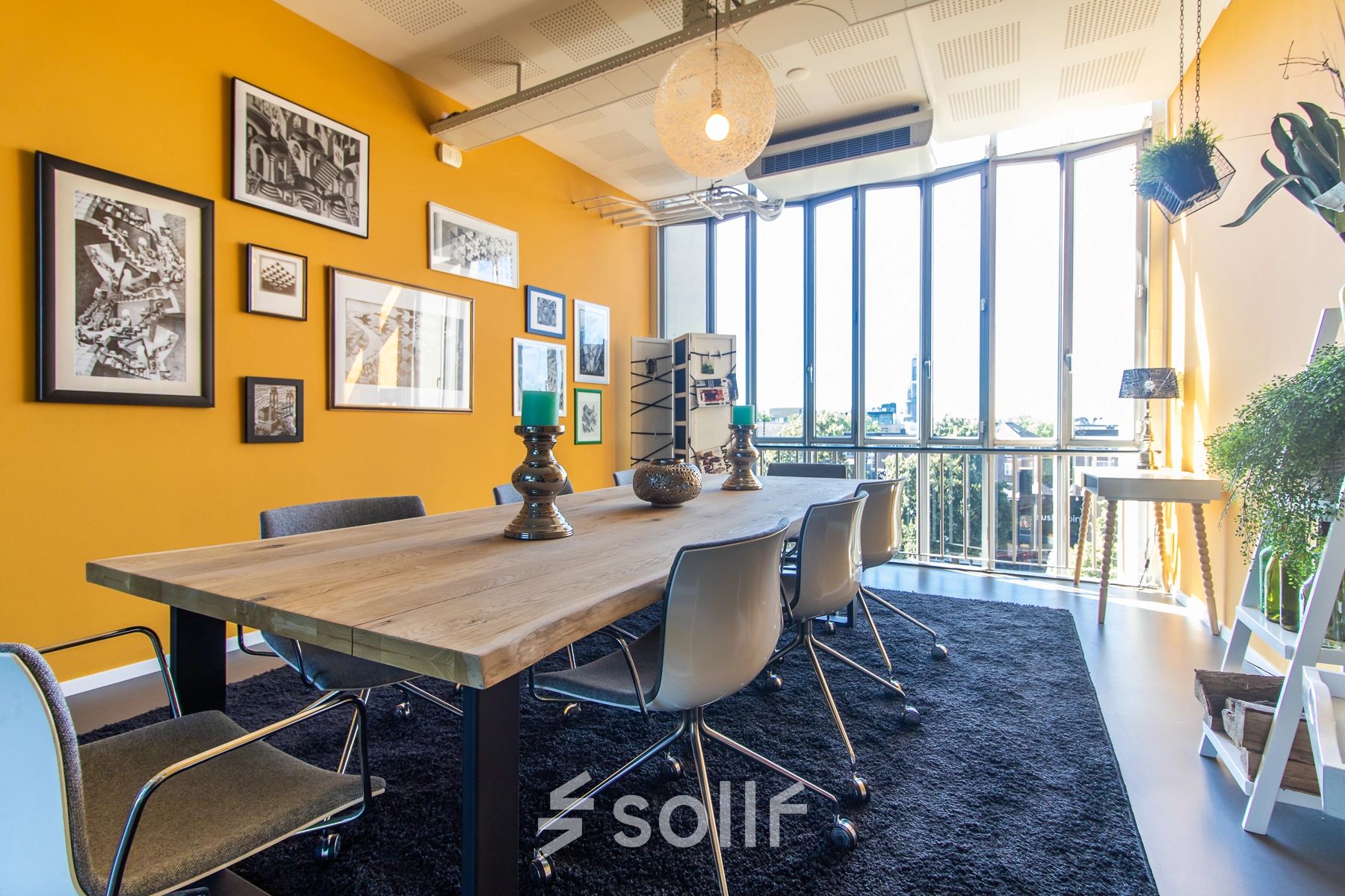 Bright office to rent at Jansbuitensingel 7, Arnhem Centrum, featuring a furnished meeting area with large windows and vibrant decor.