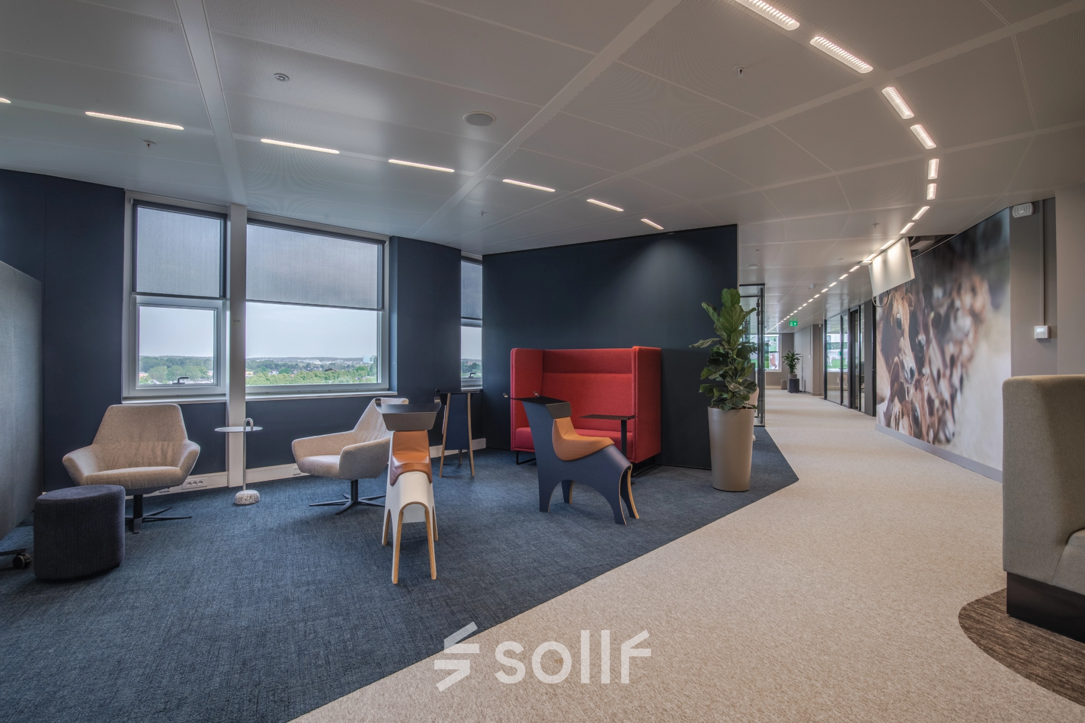 Modern office space for rent at Rijksweg-West 2, Arnhem Zuid, featuring comfortable seating areas with stylish chairs and large windows offering natural light.