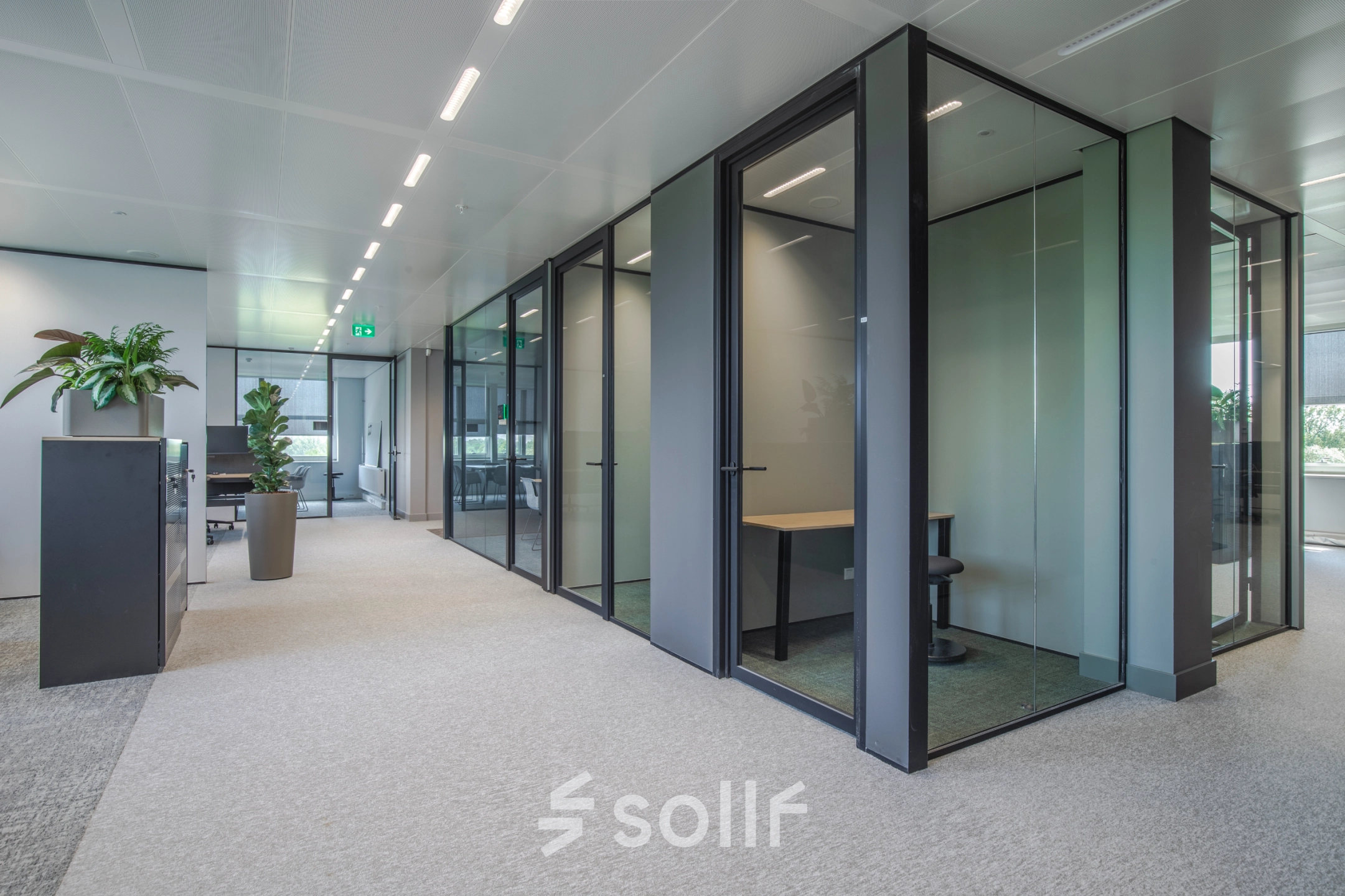 Modern office to rent at Rijksweg-West 2, Arnhem Zuid, featuring sleek glass-walled cubicles and minimal decor ideal for flexible office space rental.