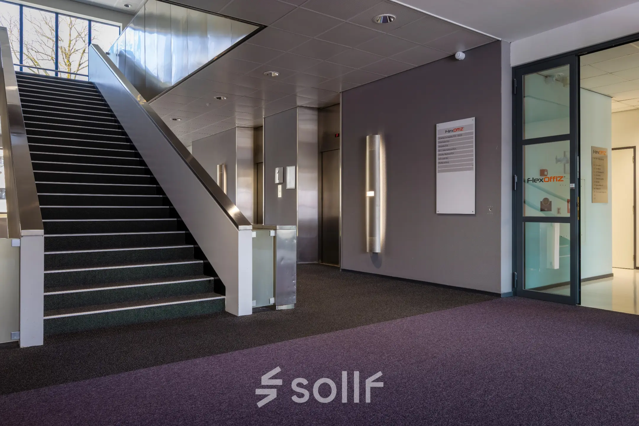 Interior view of the office entrance at Amalialaan 126, Baarn with stairs and elevator access, ideal for office space rental.