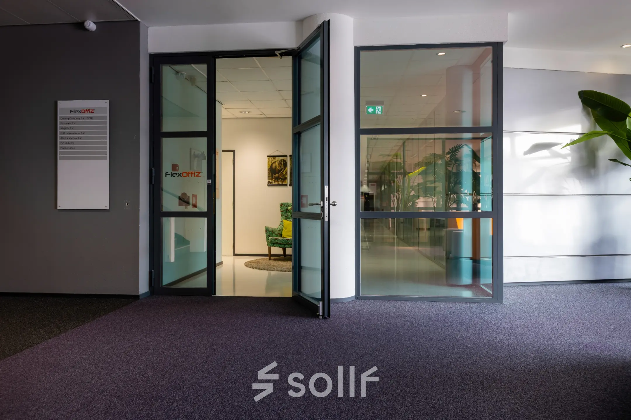 Spacious entry area at Amalialaan 126, Baarn, with glass double doors leading to office spaces available for rent.