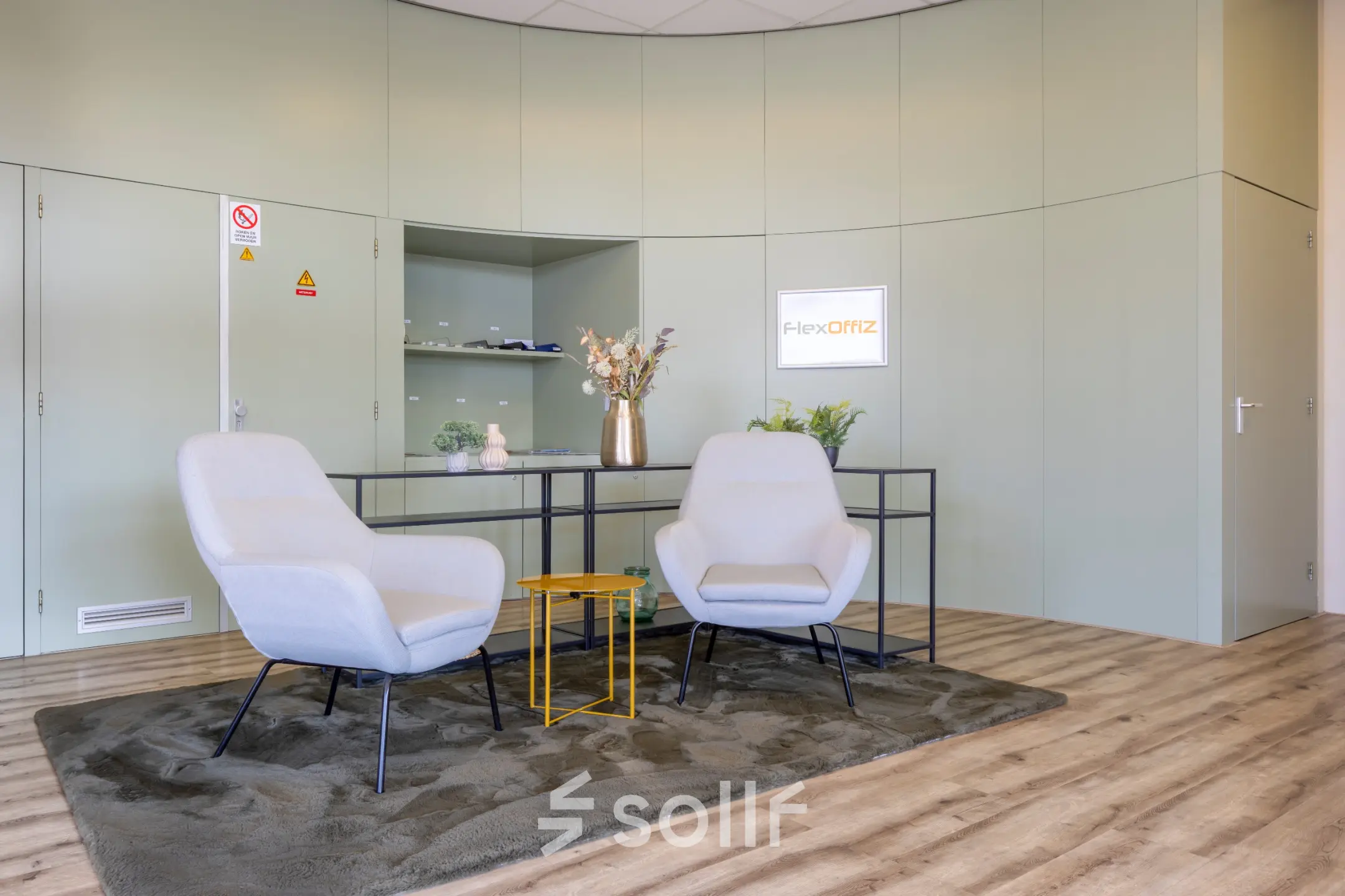 Modern office reception area with two armchairs, a table, and decorative elements at Kamerlingh Onnesweg 10, Barendrecht, ideal for office space rental.