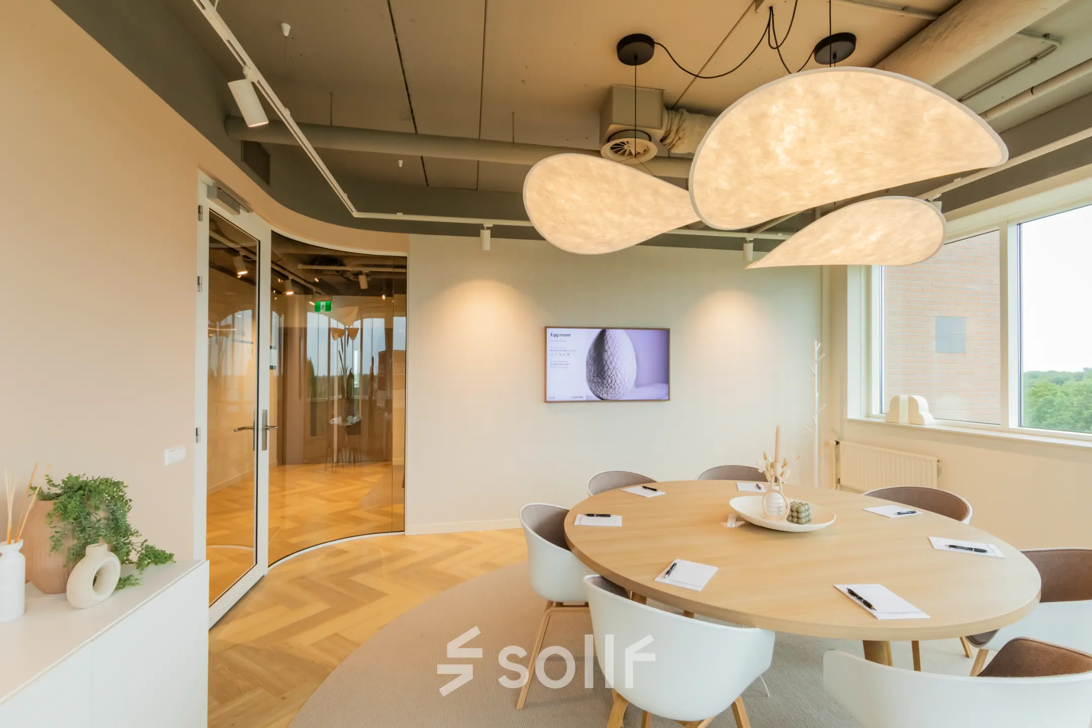 Modern furnished office space with a round table and contemporary lighting on Baron van Nagellstraat 136, Barneveld, ideal for office space rental.