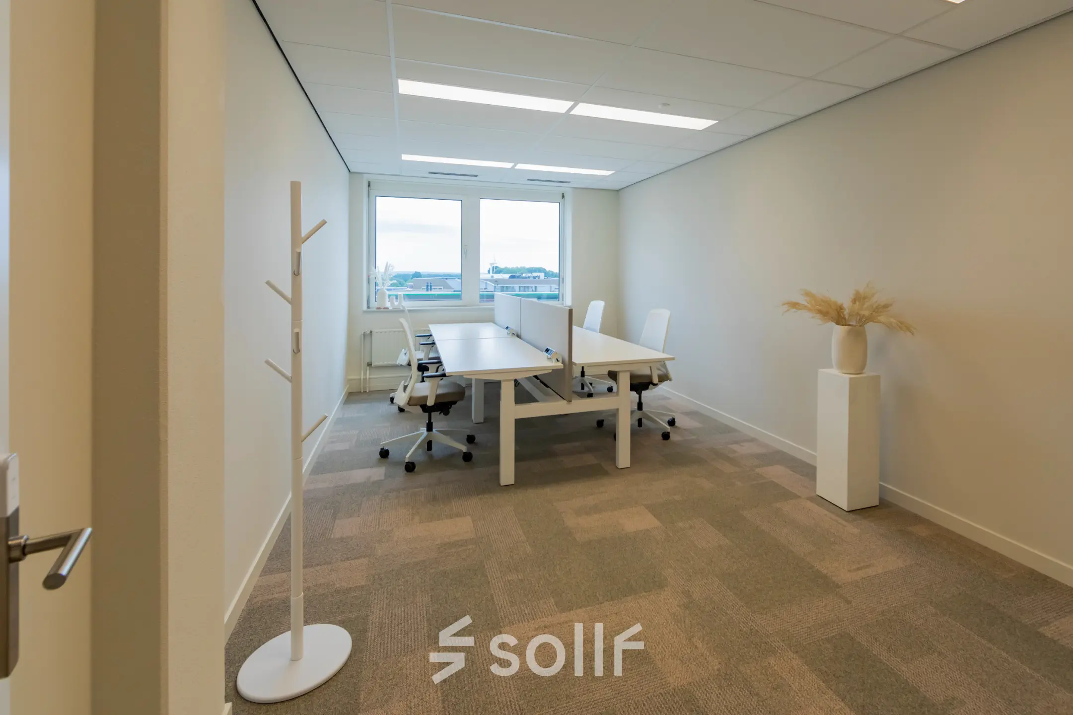 Bright office space with large window, six chairs, and a central table at Baron van Nagellstraat 136, Barneveld, perfect for office space rental.