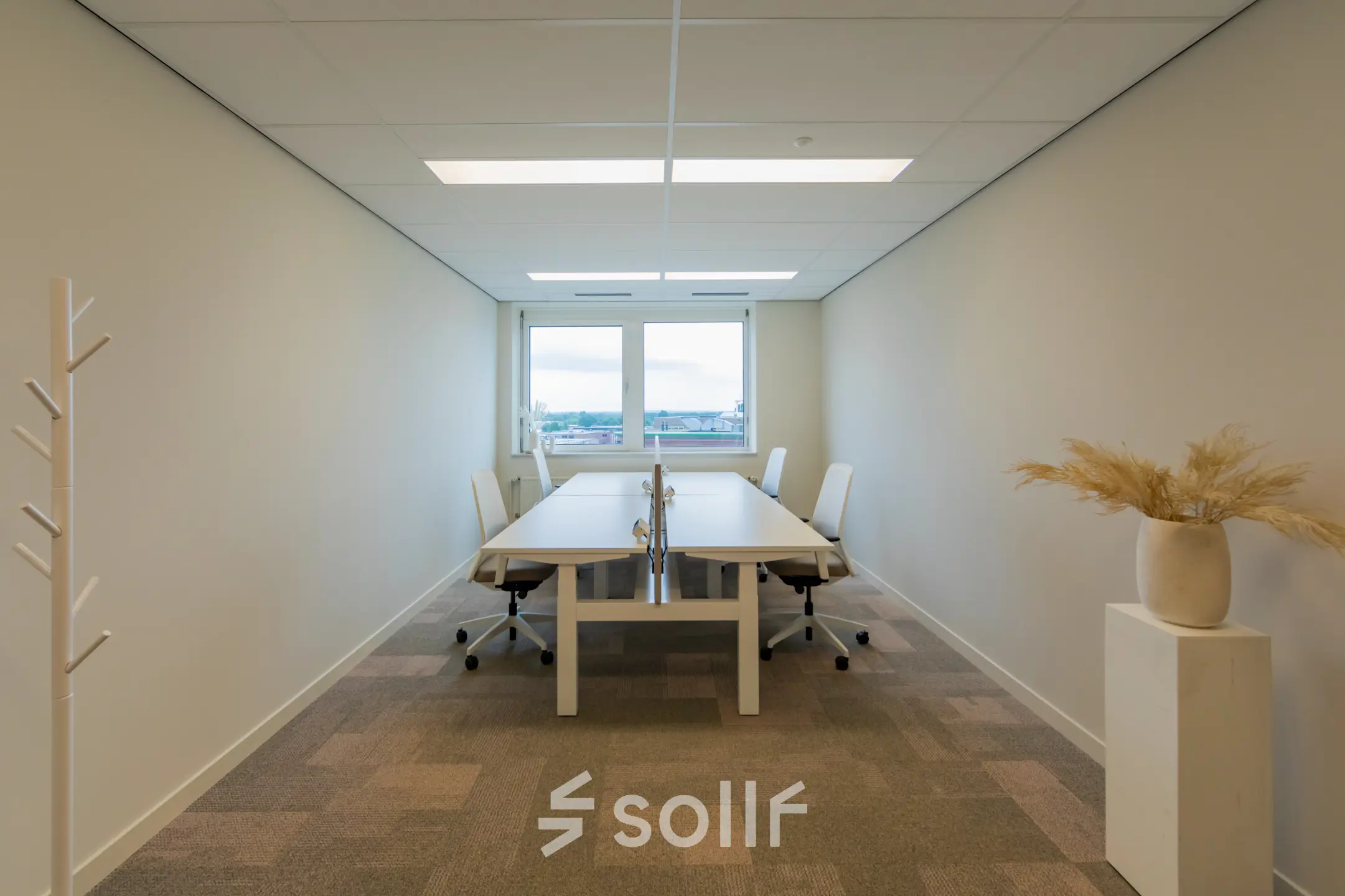 Interior view of a furnished office space rental at Baron van Nagellstraat 136, Barneveld with two desks and chairs, offering a bright and simple working environment.