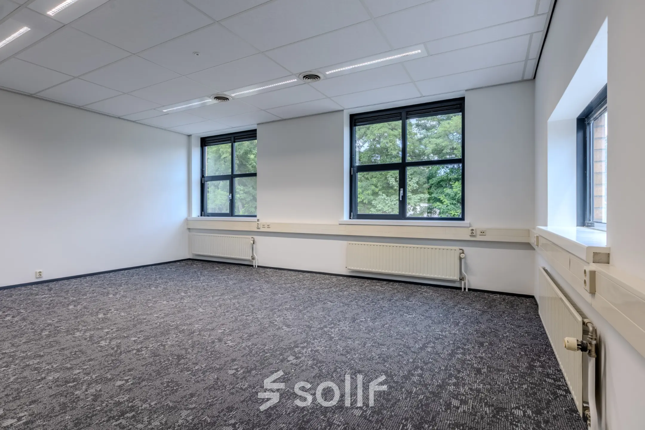 Spacious, well-lit office space with large windows at Rijtuigweg 10 for rent in Bergen op Zoom.