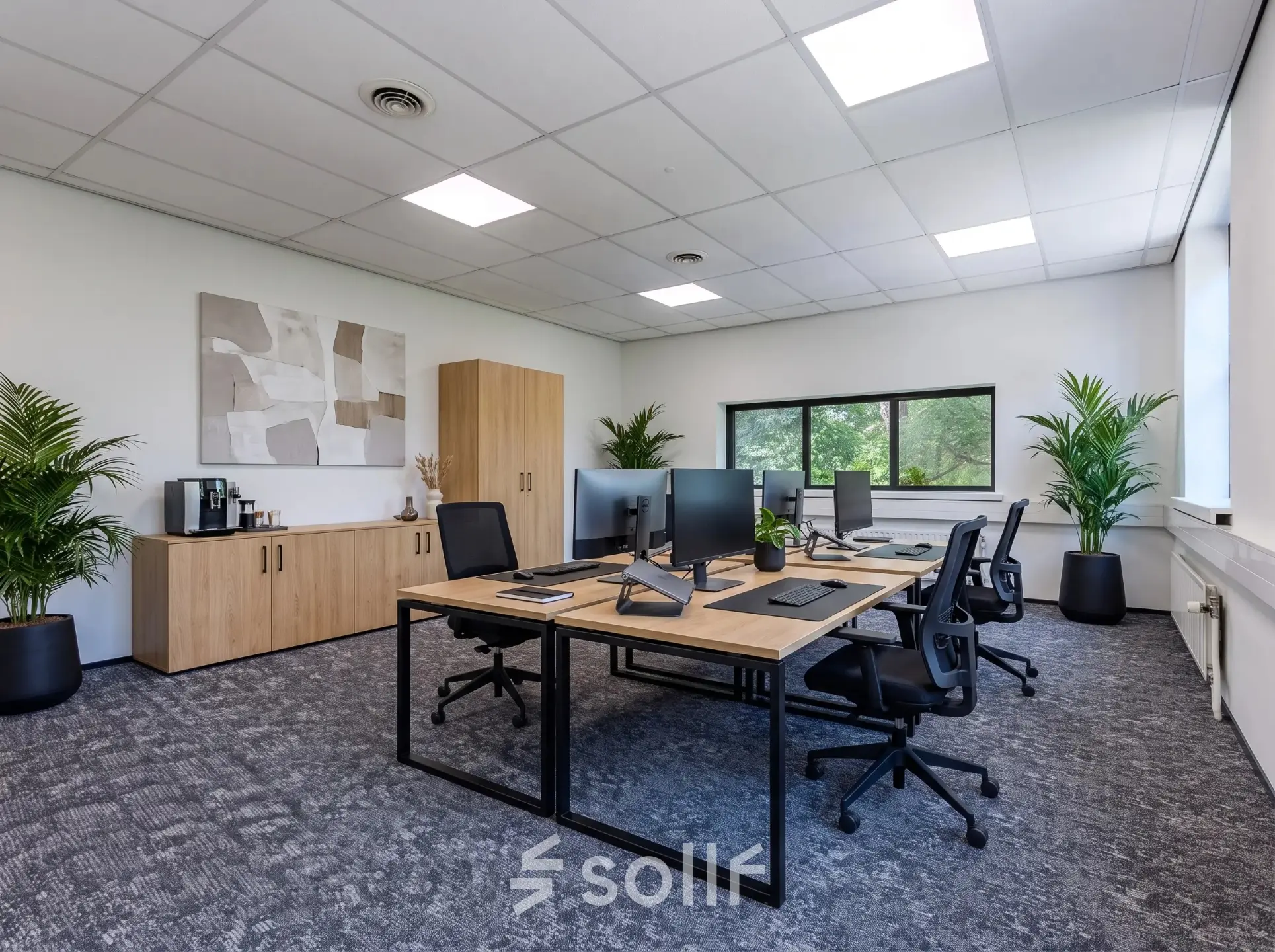 Modern furnished office space at Rijtuigweg 10, Bergen op Zoom, featuring desks, chairs, monitors, and greenery, ideal for professional office space rental.