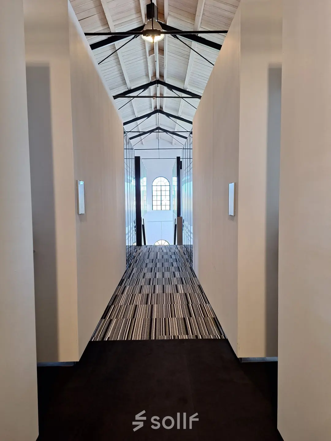 Interior view of a corridor with high ceilings and patterned flooring at Zuidzijde Haven 39a, Bergen op Zoom, ideal for office space rental.