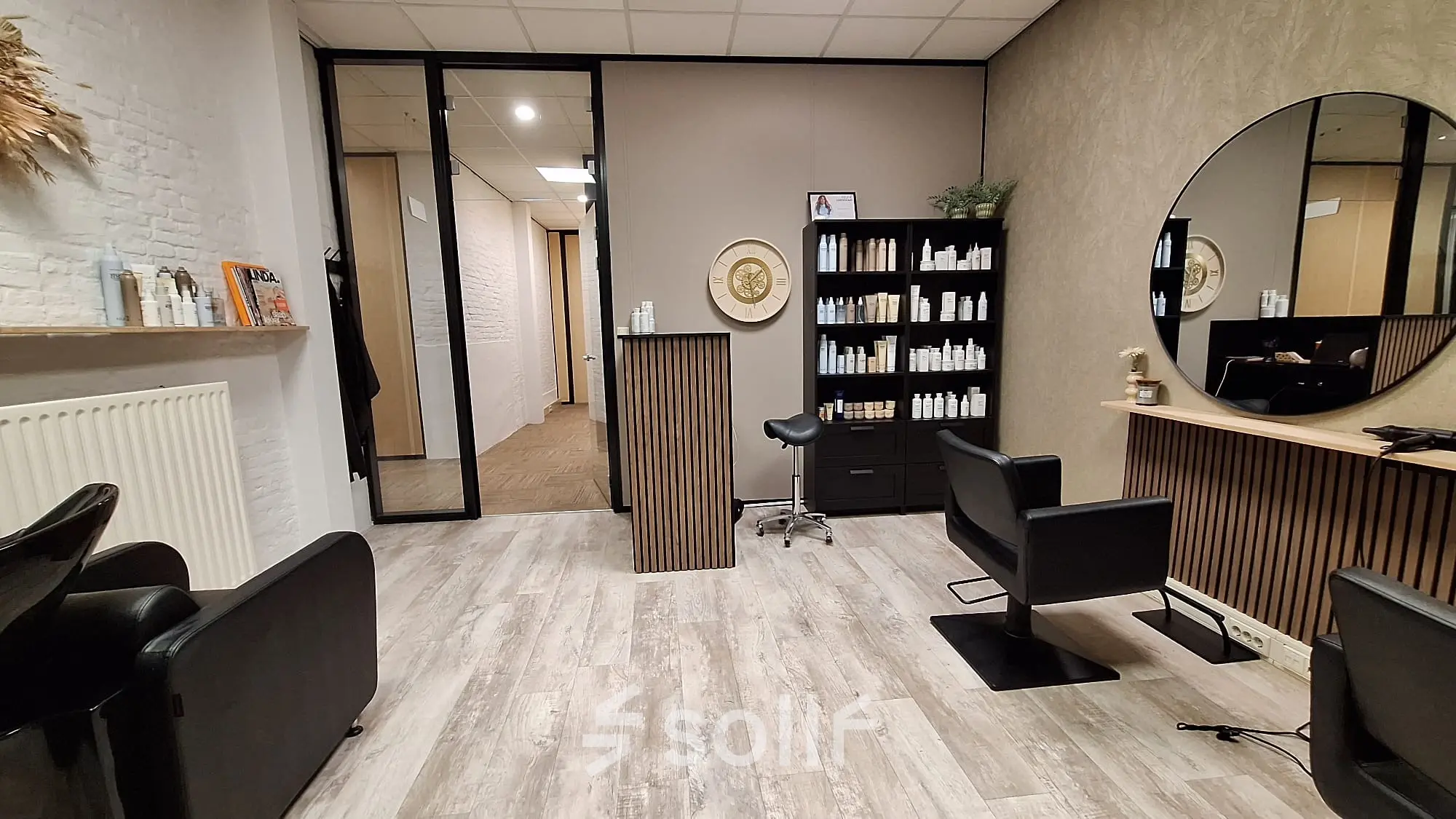 Furnished office space at Zuidzijde Haven 39a, Bergen op Zoom, featuring stylish chairs, wooden flooring, and a wall mirror, available for office space rental.