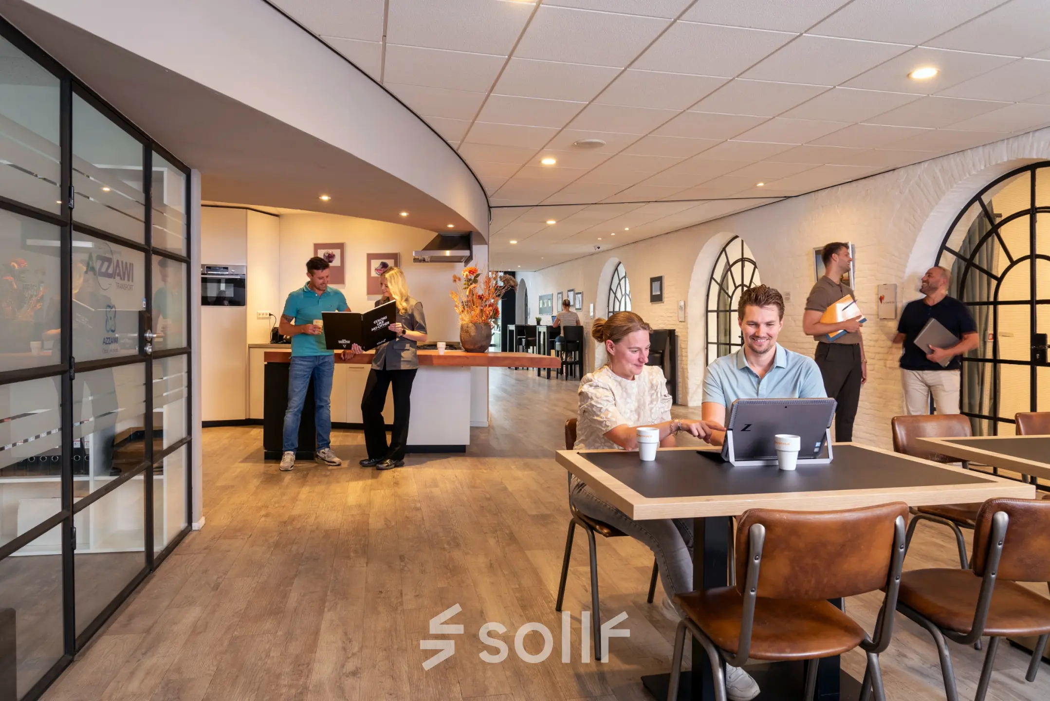 Bright office space at Zuidzijde Haven 39a, Bergen op Zoom featuring professionals collaborating and working on laptops, ideal for office space rental.