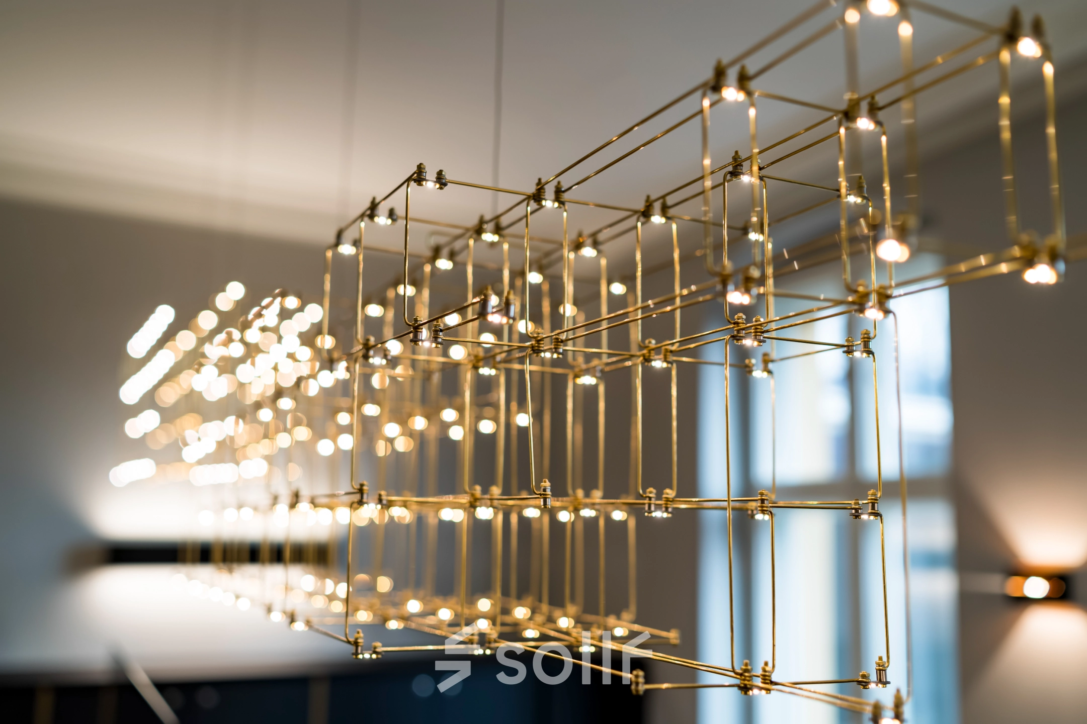 Close-up of intricate gold lighting fixture in an office space at Kurfürstendamm 15, Berlin Charlottenburg, available for office space rental.