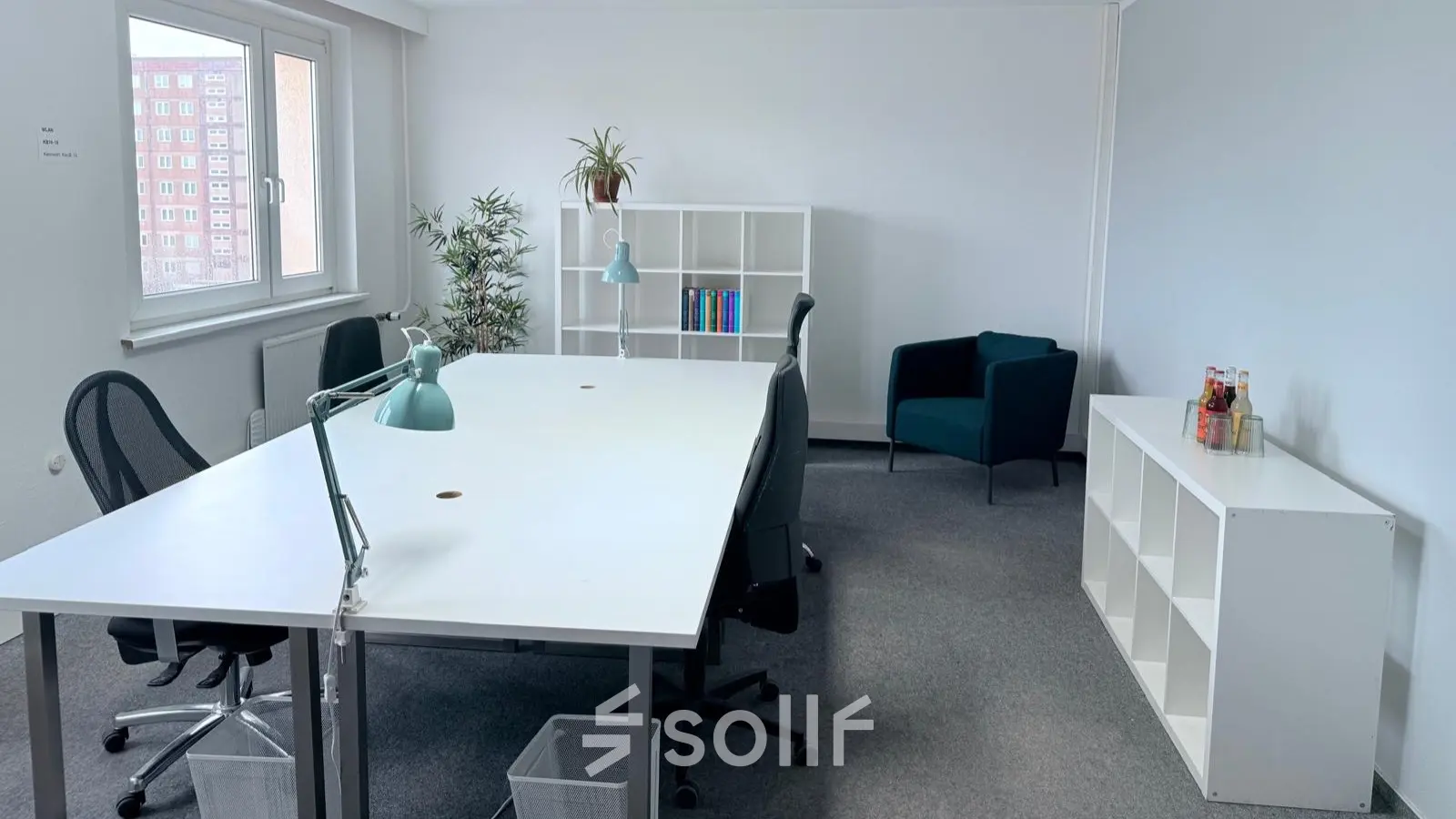 Bright office space in Berlin Friedrichshain with white desks, chairs, and shelves, ideal for office space rental.