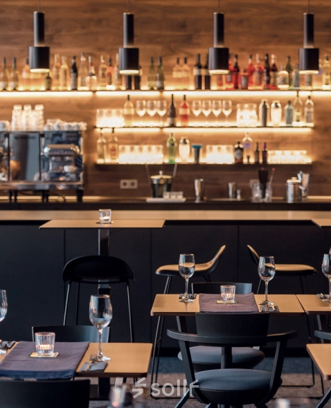 Stylish office lounge at Koppenstraße 93, Berlin Friedrichshain with a modern bar setup and seating, ideal for relaxed meetings. Perfect for those seeking office space rental with character.