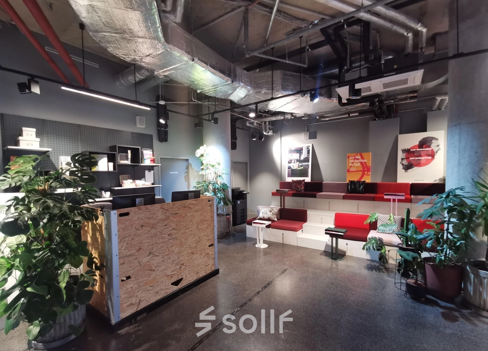 A stylish office space at Koppenstraße 93, Berlin Friedrichshain, featuring modern seating and an open layout with plants and decor, available for rent.
