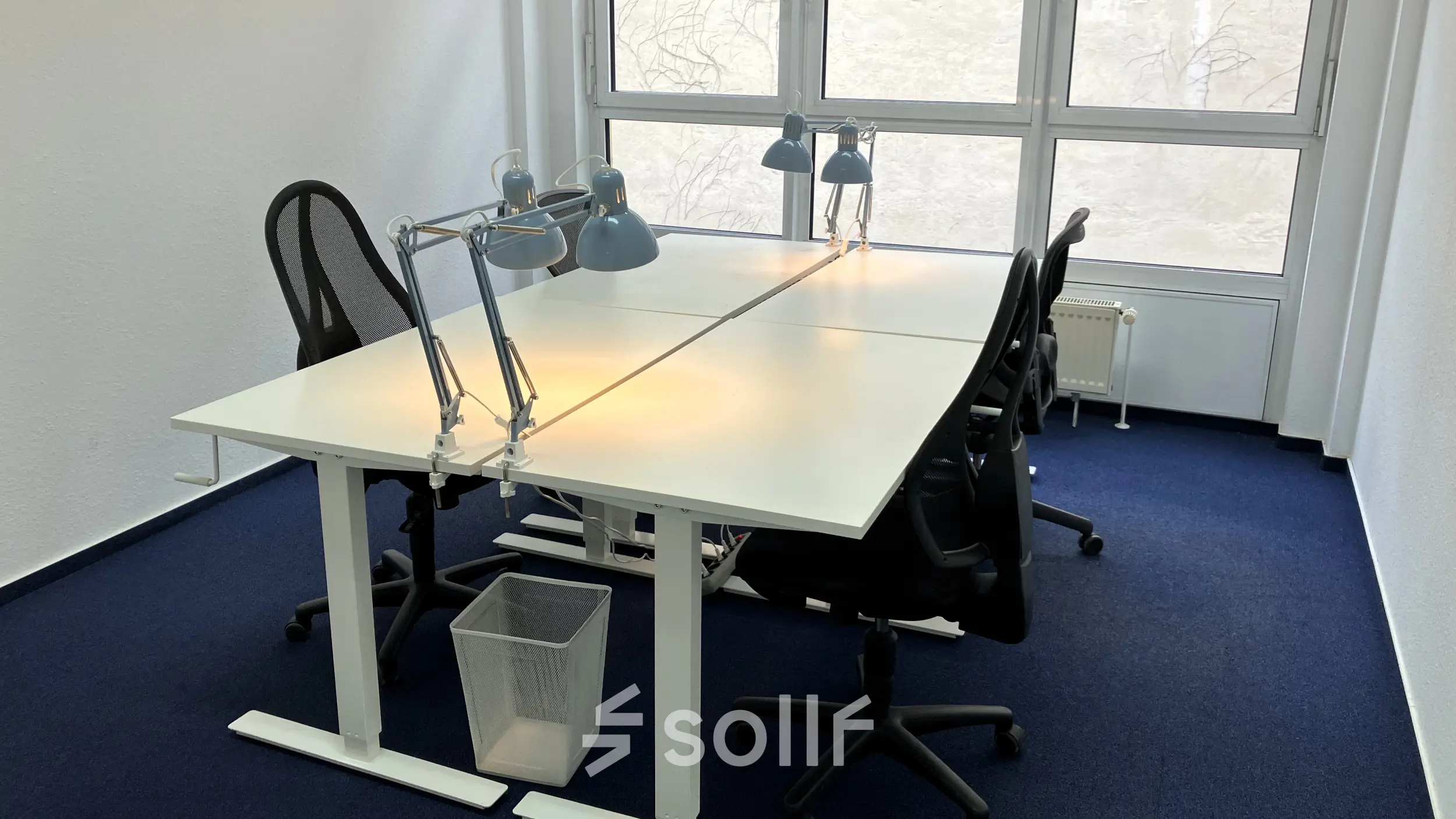 Office space rental at Boppstraße 7, Berlin Kreuzberg, featuring a bright, functional interior with desks, chairs, and desk lamps near large windows.