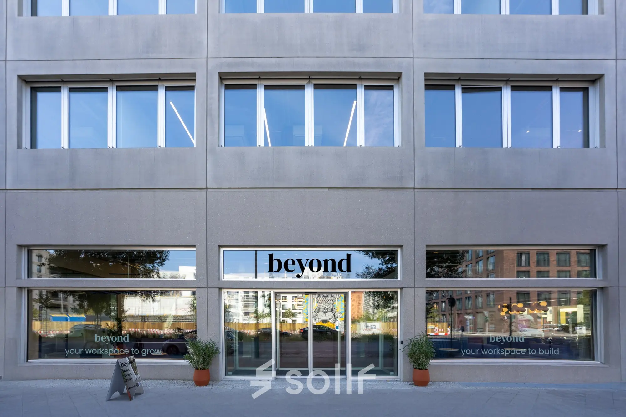Exterior view of the office to rent at Heidestraße 34, Berlin Mitte, showcasing large windows and a modern façade.