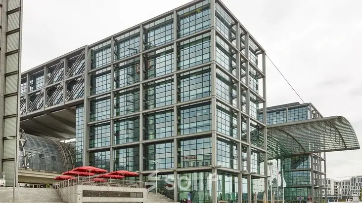 Exterior view of a modern office building at Europaplatz 2, Berlin Moabit, an ideal spot for office space rental with large glass windows.