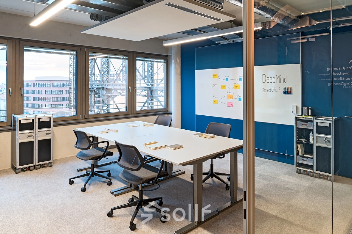 Modern conference room at EUREF-Campus 22 in Berlin Schöneberg, featuring a large table and chairs, ideal for office space rental.