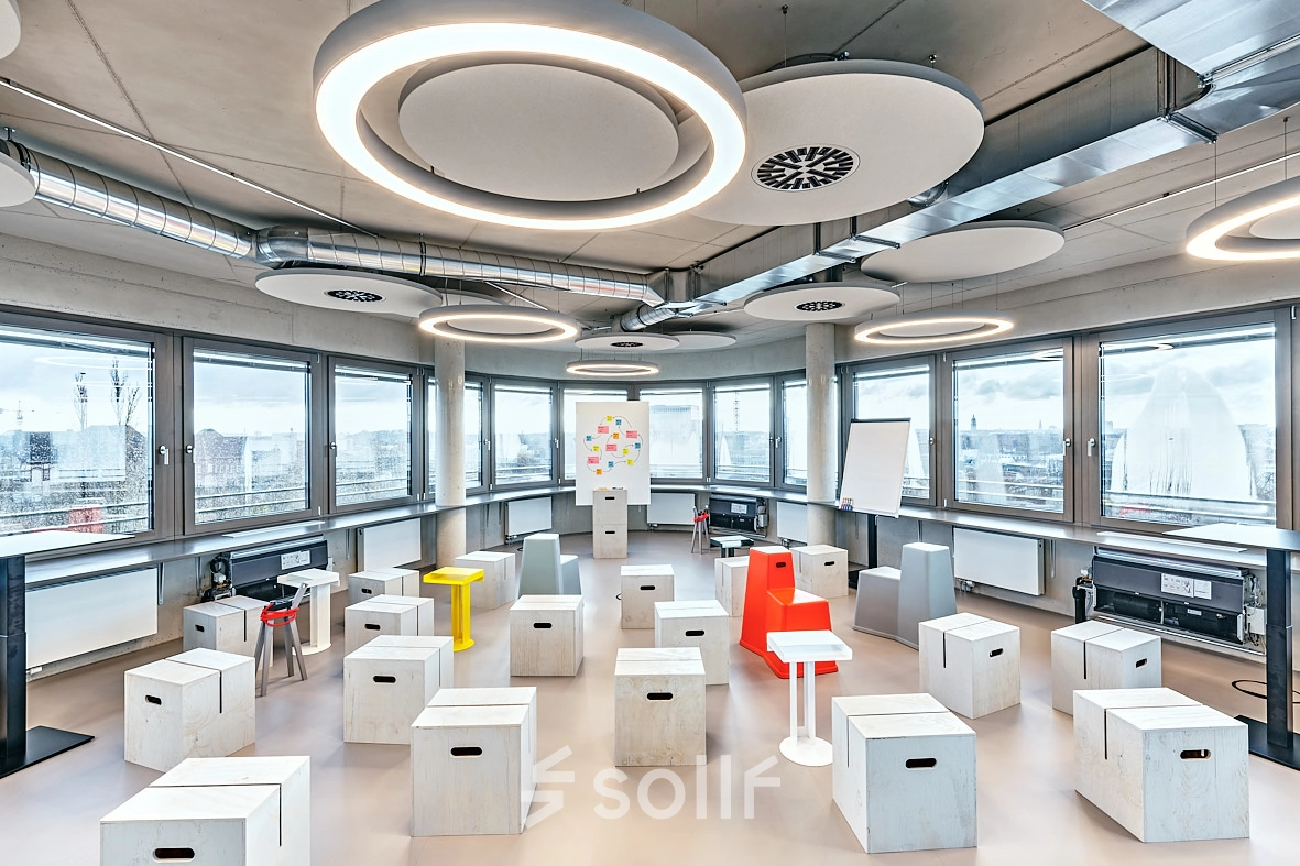 Spacious and unique office to rent at EUREF-Campus 22 in Berlin Schöneberg, featuring modern furnishings and large windows providing city views. Ideal for innovative office space rental.