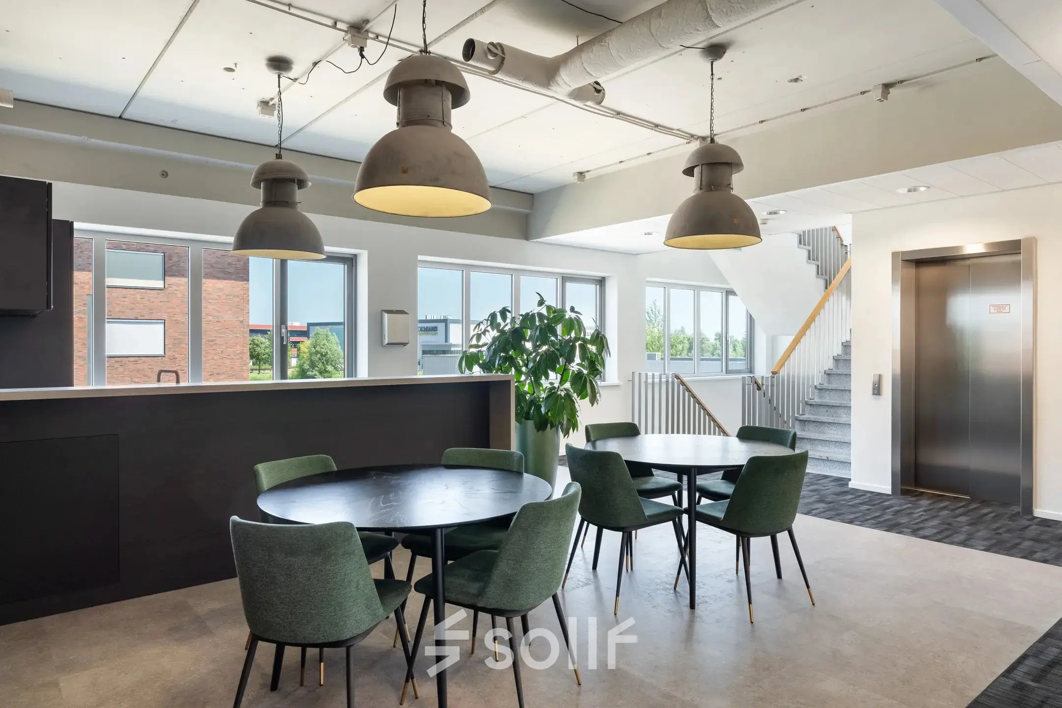 Spacious office to rent at Tolnasingel 1 - 3, Bodegraven featuring modern furnishings with round tables and chairs, surrounded by natural light from large windows.