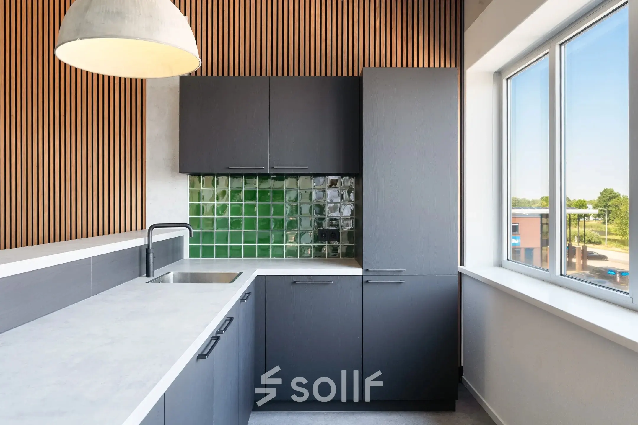 Modern office pantry with sleek cabinets and a green tiled backsplash at Tolnasingel 1 - 3, Bodegraven, ideal for office space rental.