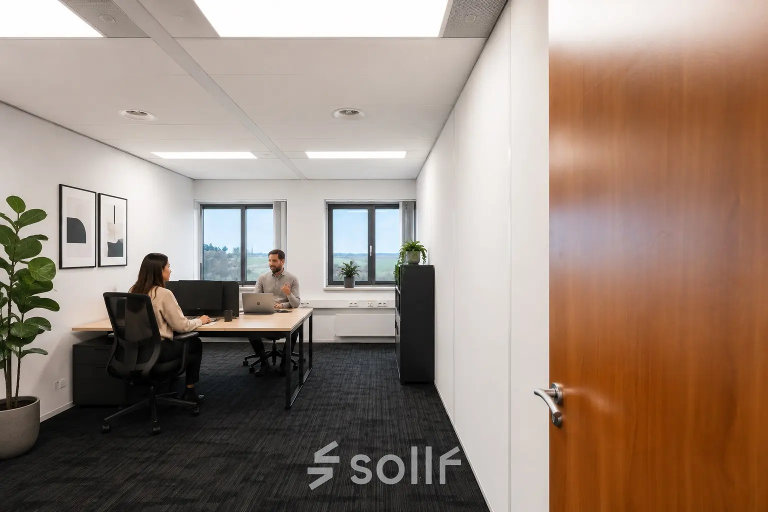 Office space rental in Tolnasingel 1 - 3, Bodegraven, featuring two professionals engaged in a meeting around a shared desk, highlighting an inviting workspace environment.