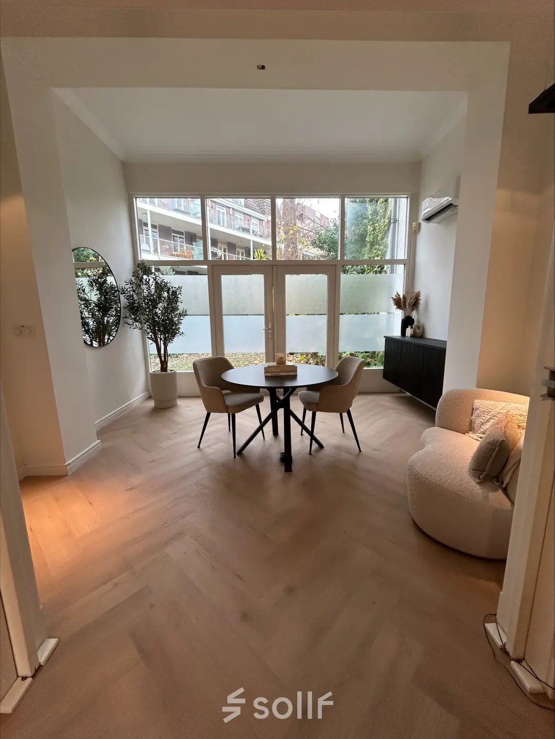 Cozy office space at Sophiastraat 40 40, Breda Centrum-Station, featuring a furnished area with a round table, chairs, and a plush armchair, ideal for office space rental.