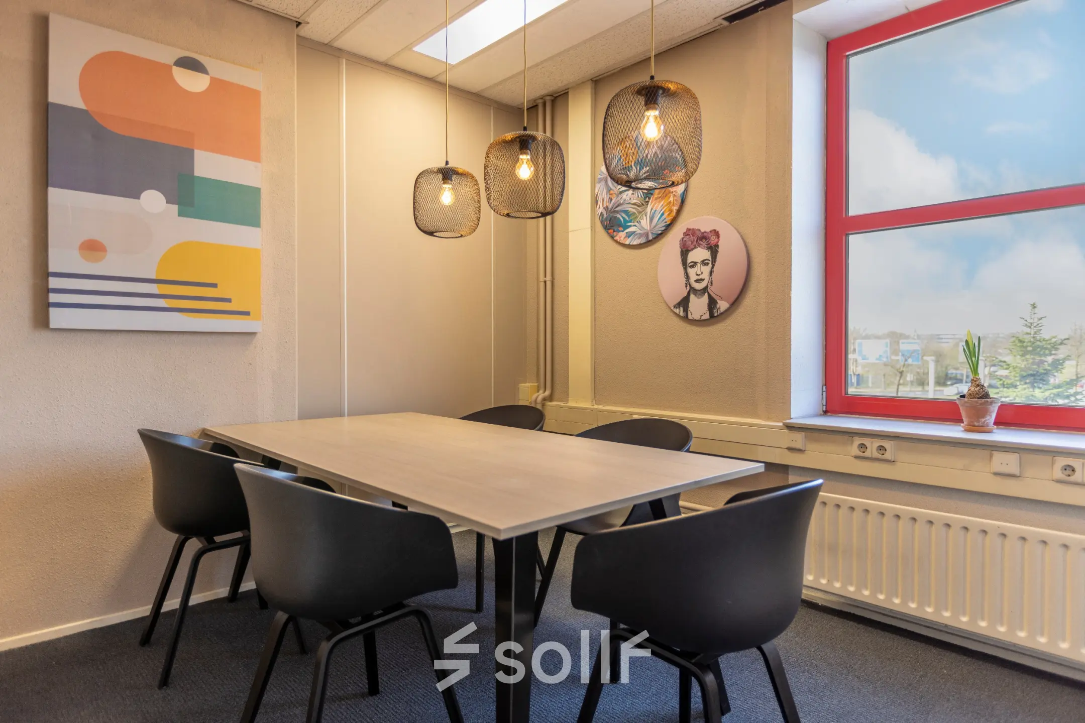 A furnished office space rental at Takkebijster 57A, Breda Oost-Brabantpark, featuring a meeting room with modern decor, a table, and chairs under stylish lighting.