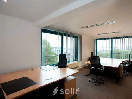 Bright office space with large windows and modern desks in Bremen Neustadt, perfect for office space rental.