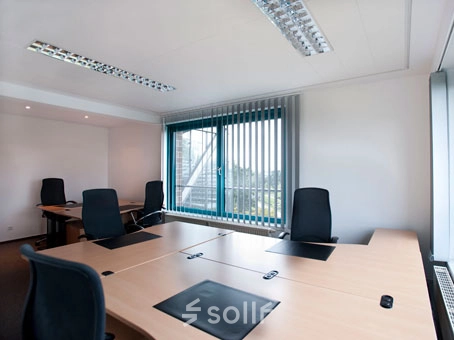 Spacious office at Flughafenallee 26 in Bremen Neustadt with multiple workstations, available for rent office space. Bright room with large windows and modern furniture.