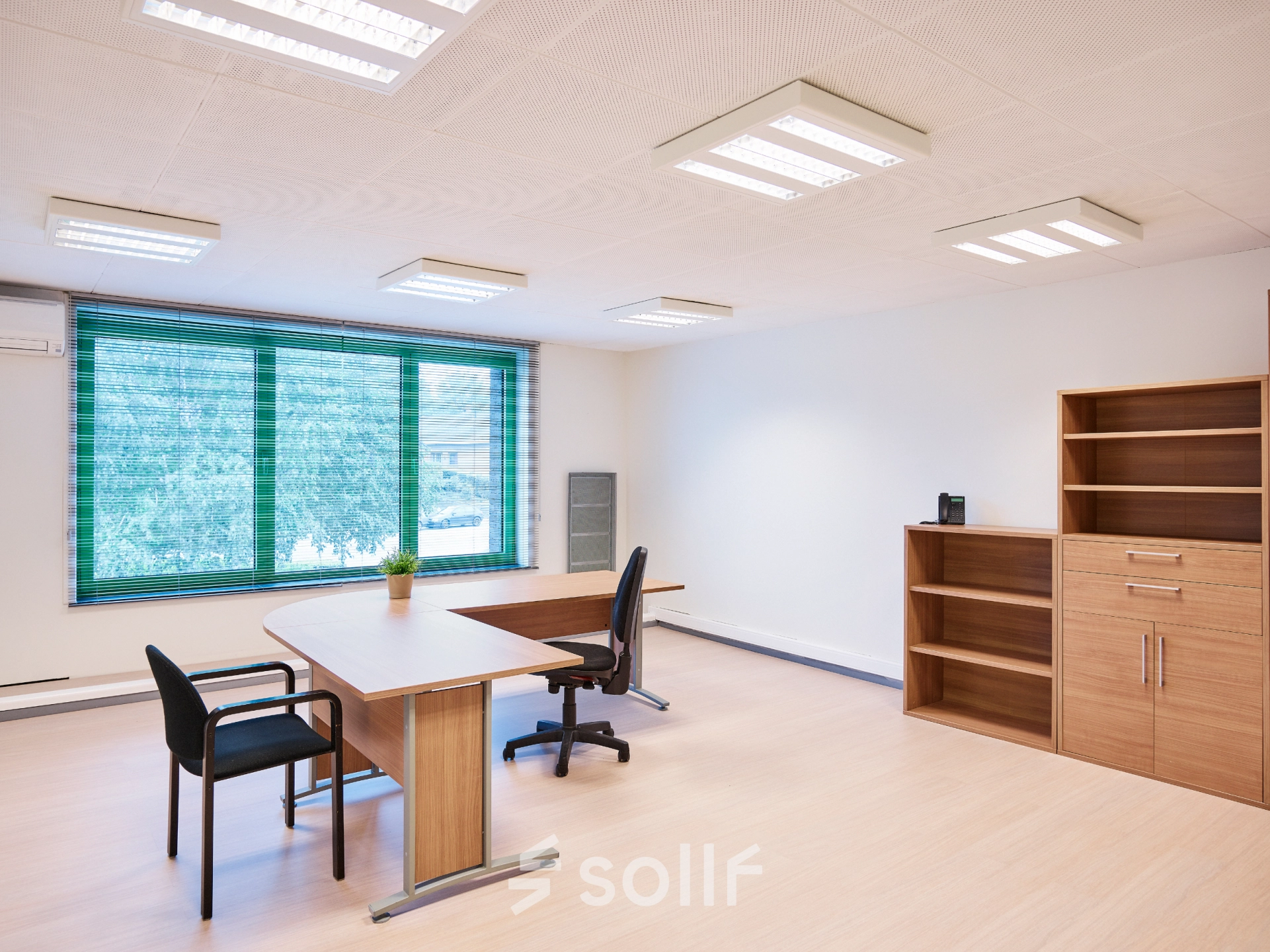 Bright office space with wooden furniture and large window view, available for rent at Leuvensesteenweg 613, Brussels Airport.