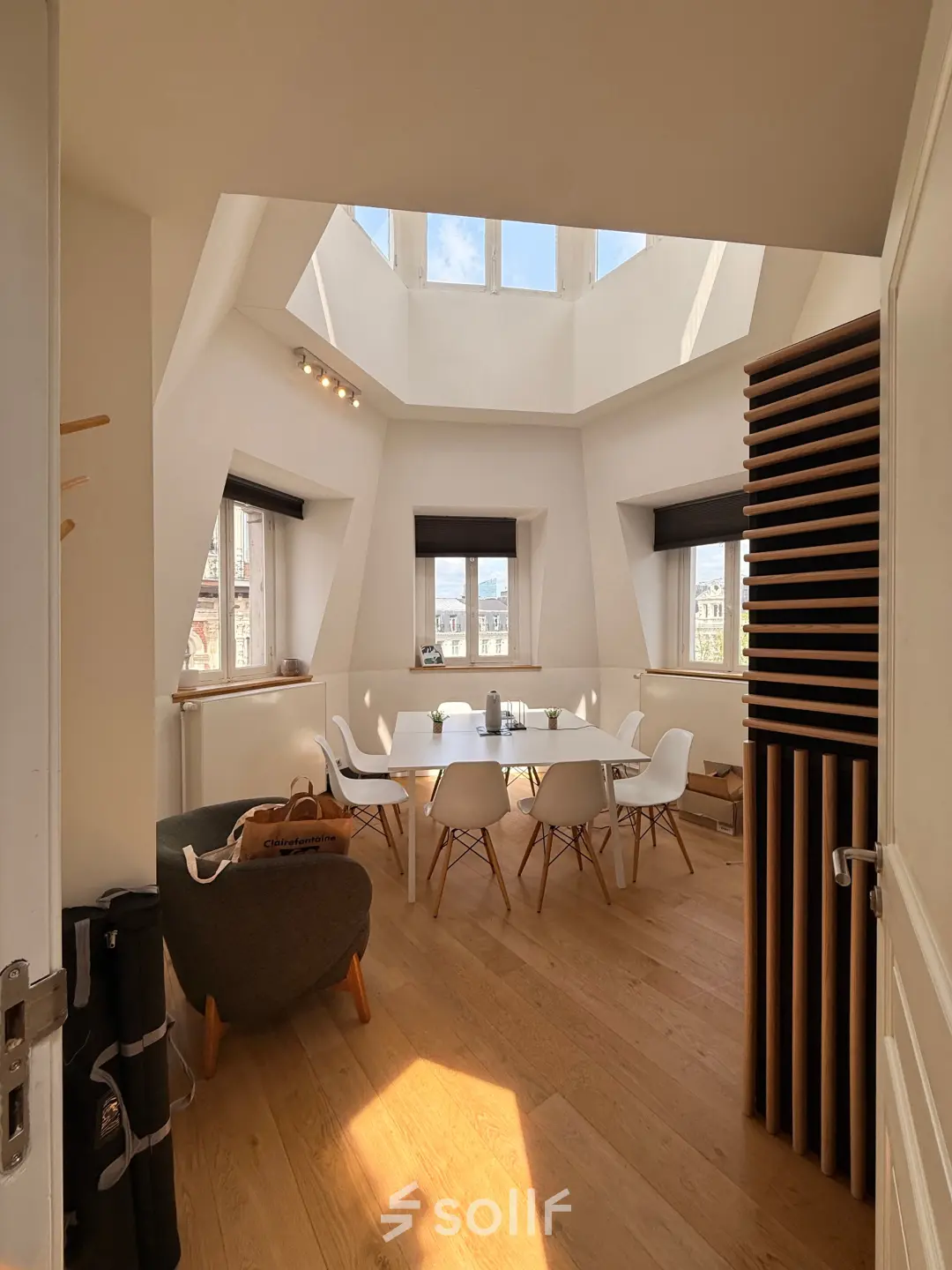 Bright office space at Rue du Congres 37, Brussels Center, featuring a skylight and modern furnishings ideal for rental.