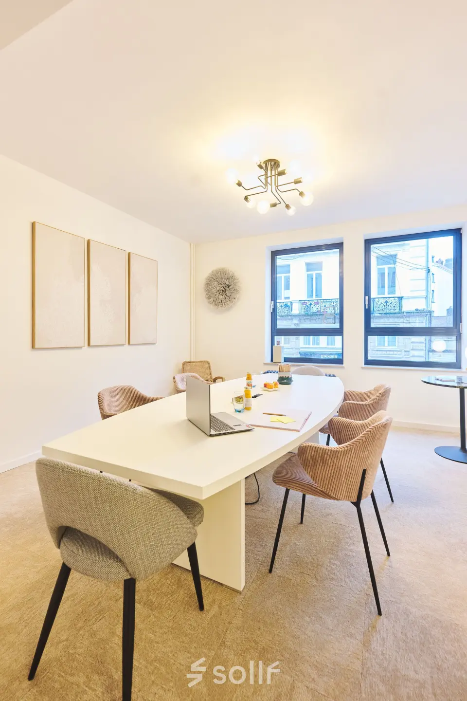 Bright office space at Rue du Congres 37, Brussels Center, showcasing a contemporary meeting area with a long table and modern chairs, available for rent.
