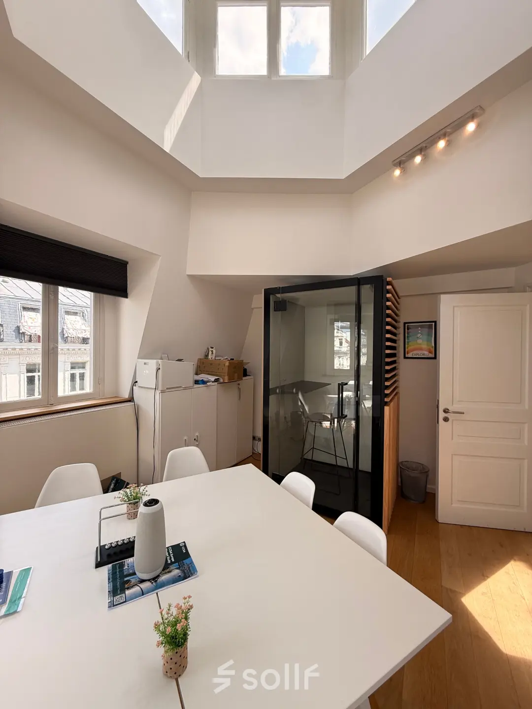 Sunny office to rent at Rue du Congres 37, Brussels Center, featuring a meeting pod and natural light through skylights.