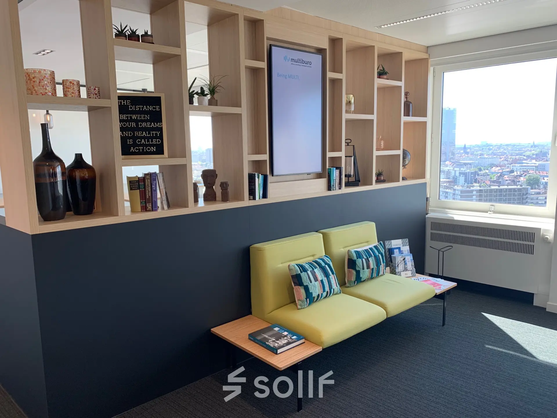 A well-lit office space at Rue Joseph Stevens 7 in Brussels Center, featuring modern seating and decorative shelves, ideal for an inviting office to rent experience.