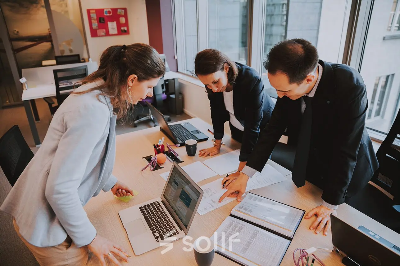 Professionals collaborating in an office space at Rue Joseph Stevens 7, Brussels Center, ideal for office space rental.